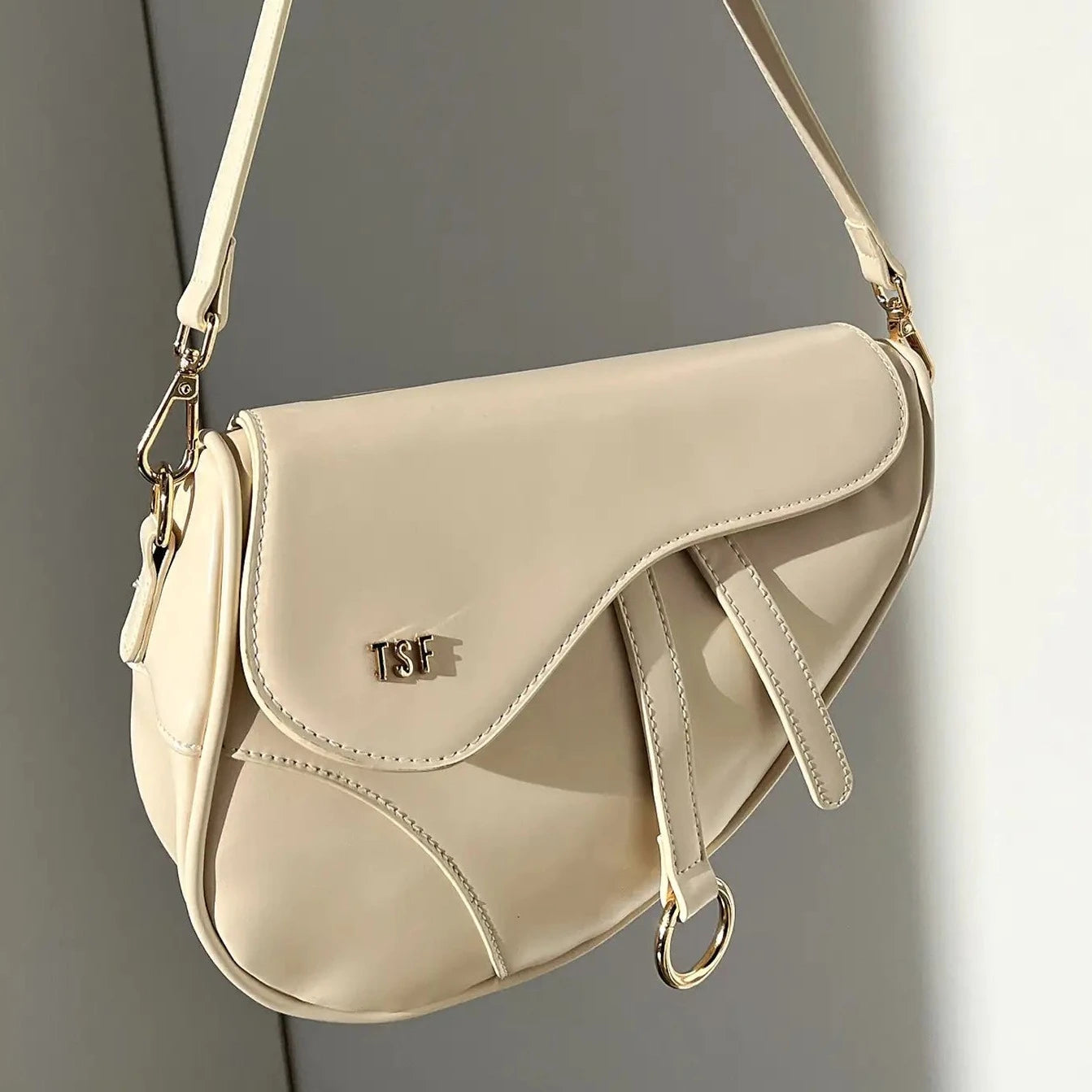 Sophisticated Saddle-Shaped Shoulder Bag with Gold Accents